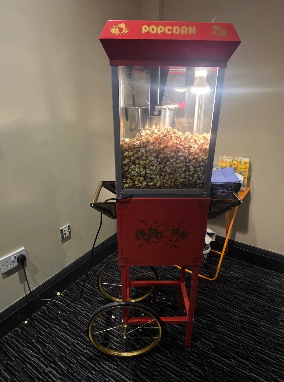 Our red popcorn machine cart full of fresh popcorn at Chessington World of Adventures