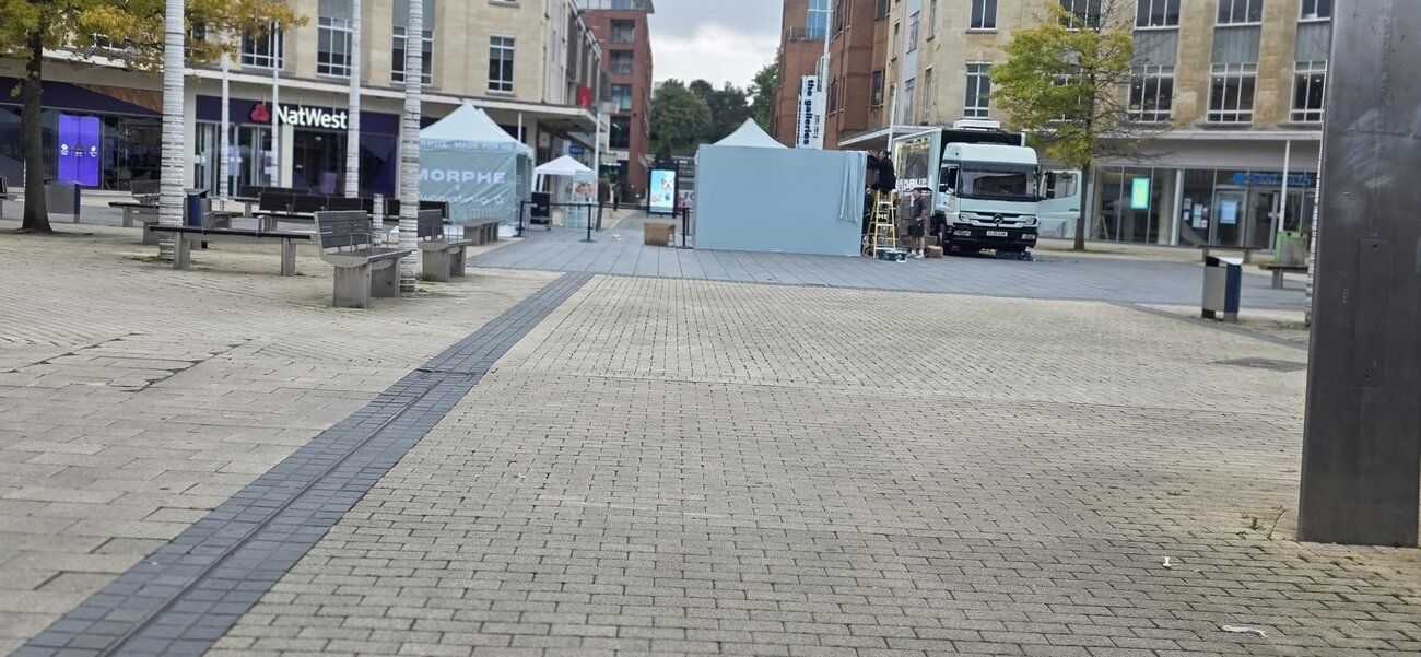 Early morning in a Bristol town-centre square — the Morphe activation being built before the crowds arrive