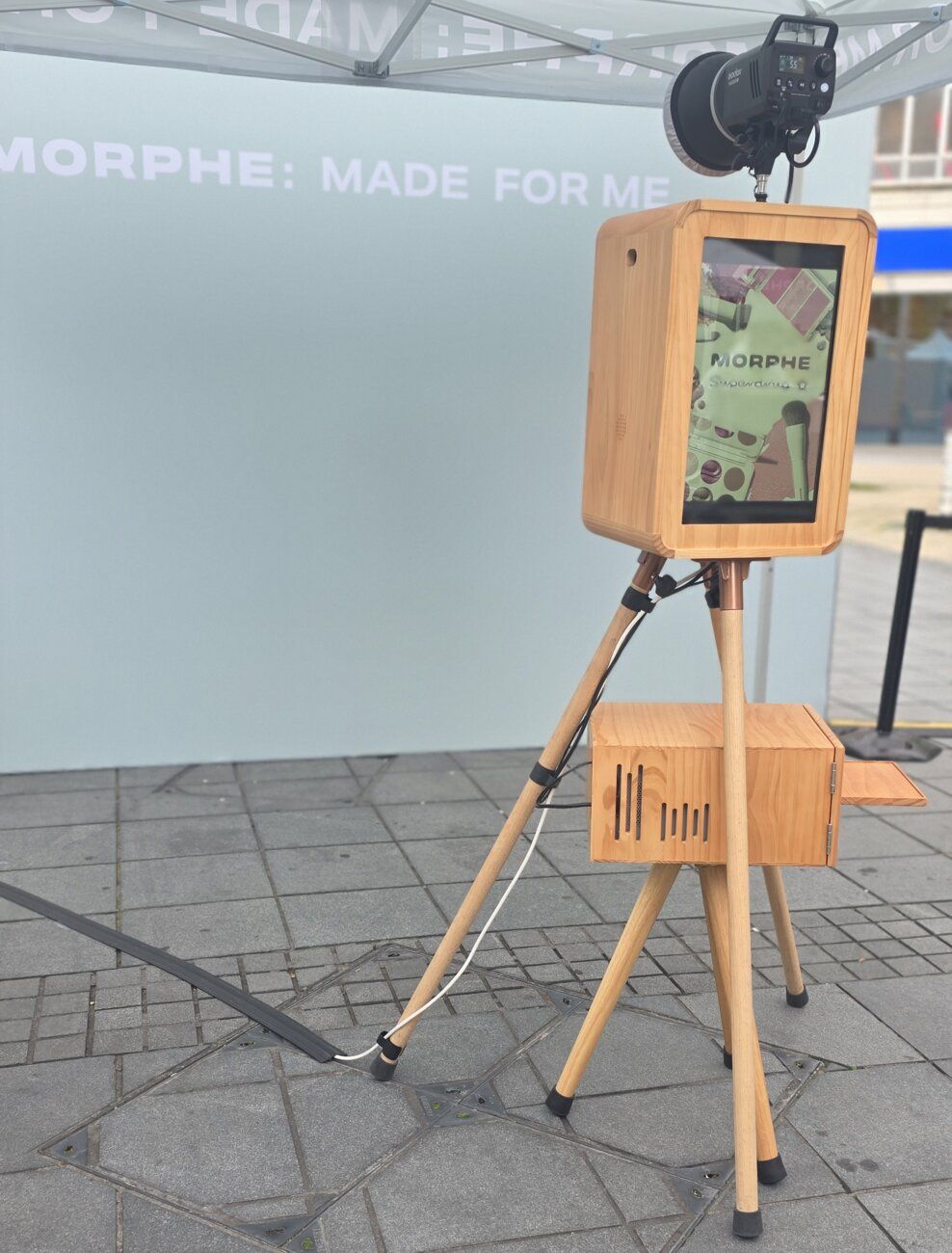 Our DSLR Vintage Photo Booth and studio flash in front of the Morphe-branded backdrop
