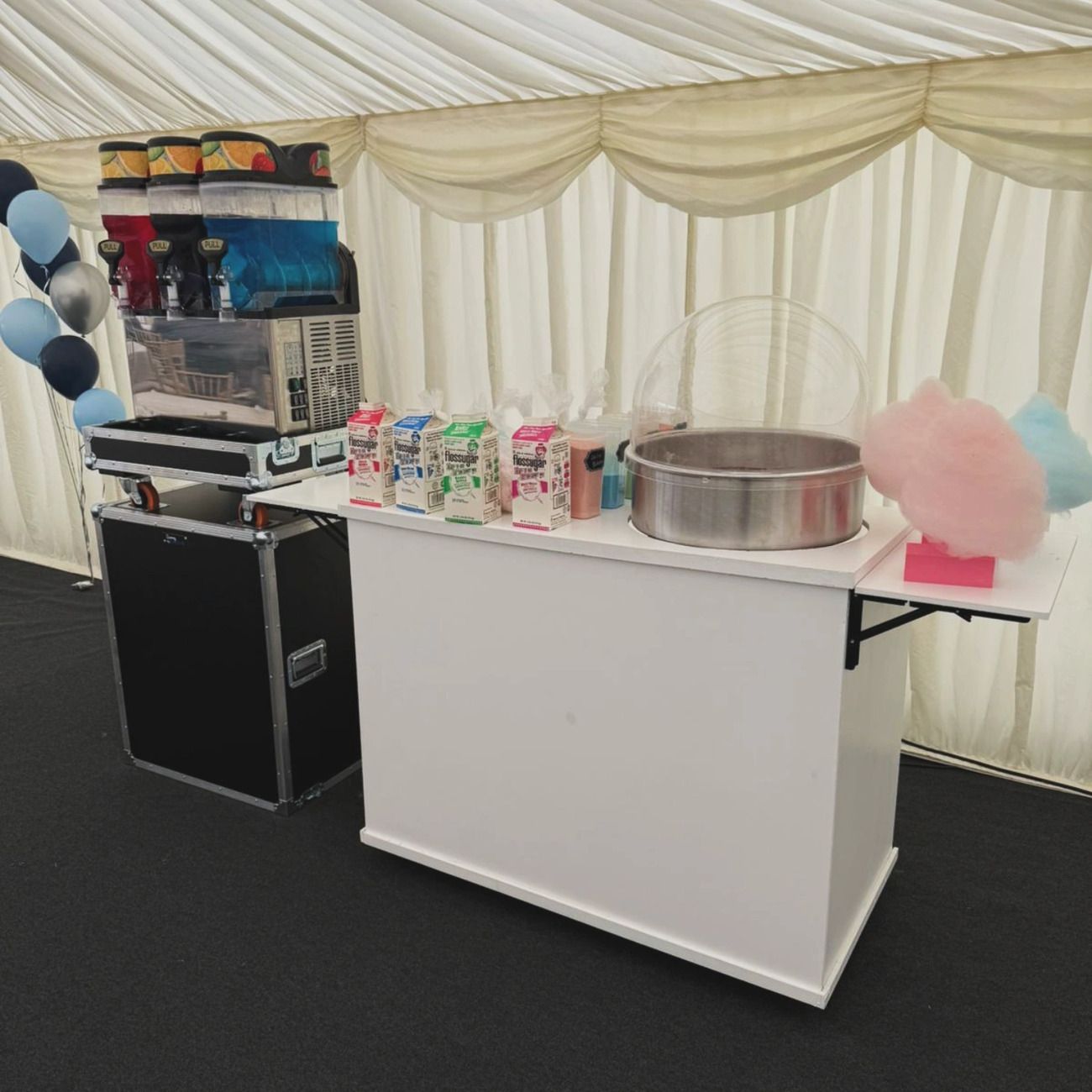 Our slush machine and candy floss station set up with flavours and fresh candy floss