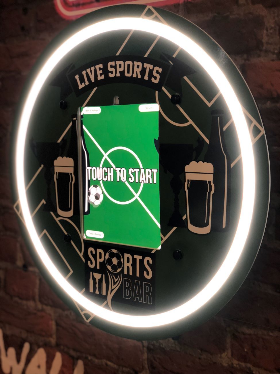 Wall-mounted photo booth — sports bar install with custom Live Sports branding