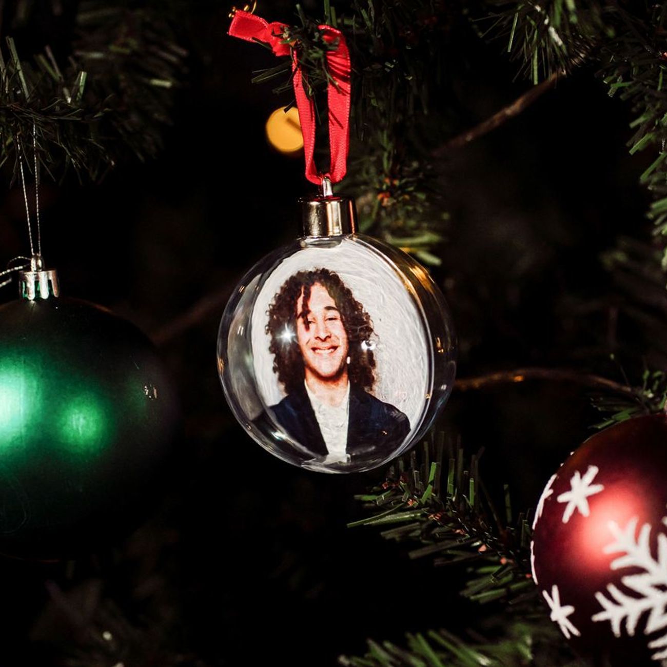Photo Bauble Hanging Between Traditional Tree Baubles