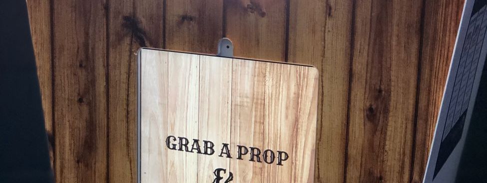 A photo booth detail reading grab a prop and strike a pose