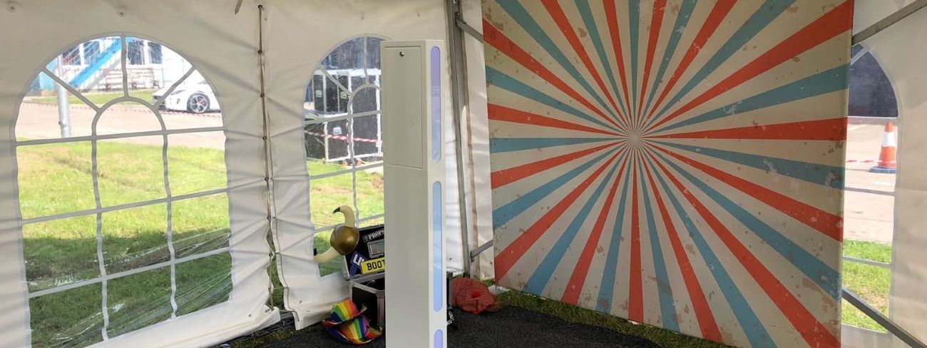 A selfie pod set up in a garden marquee at a themed summer event
