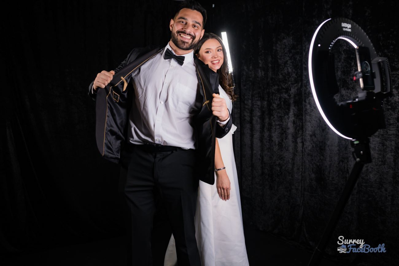 Bride and groom posing for a 360 video booth, ring light visible to the right