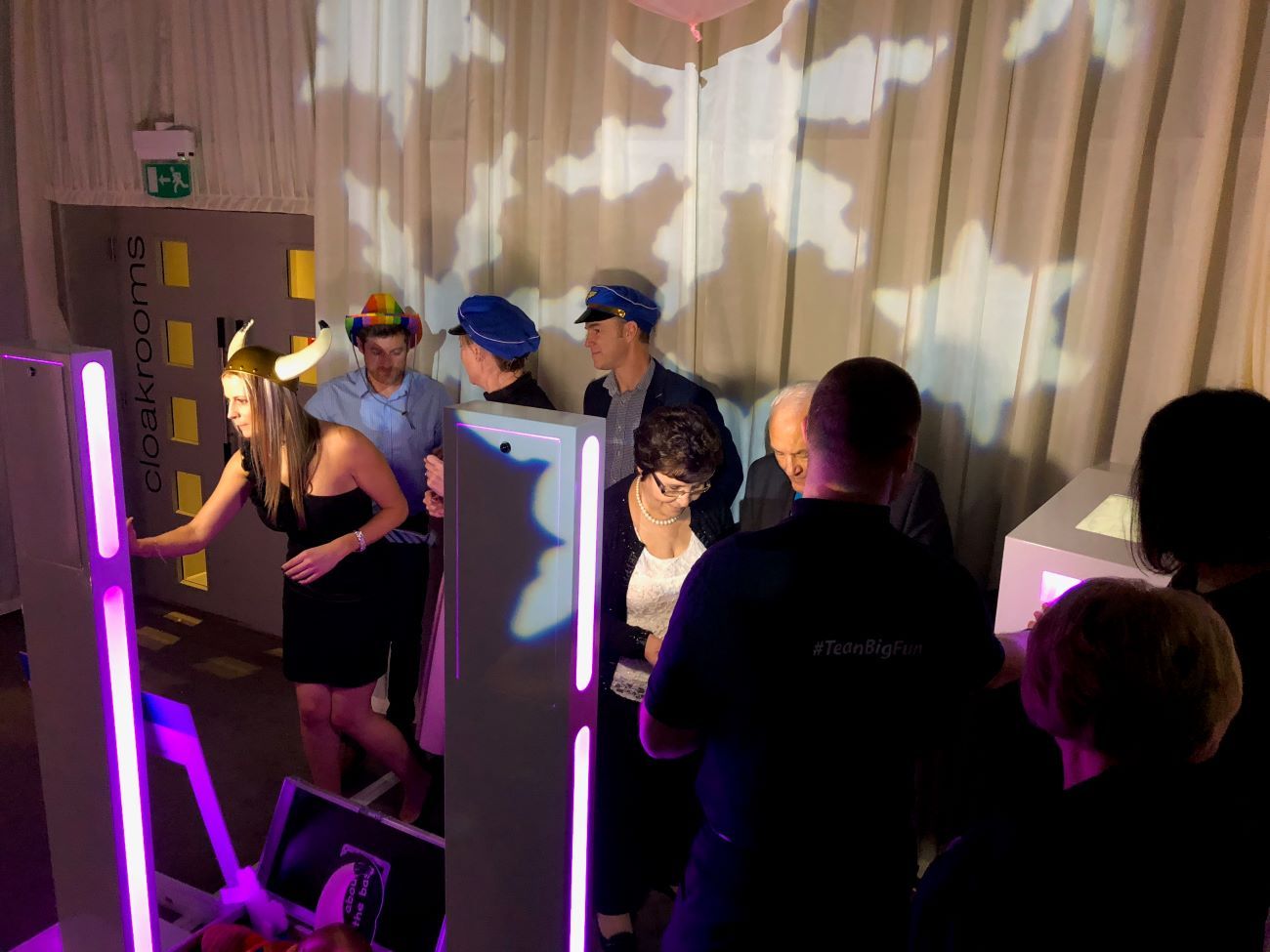 Twin selfie pods set up side by side at a corporate team-building event with star projection lighting, guests in viking, police and rainbow hats