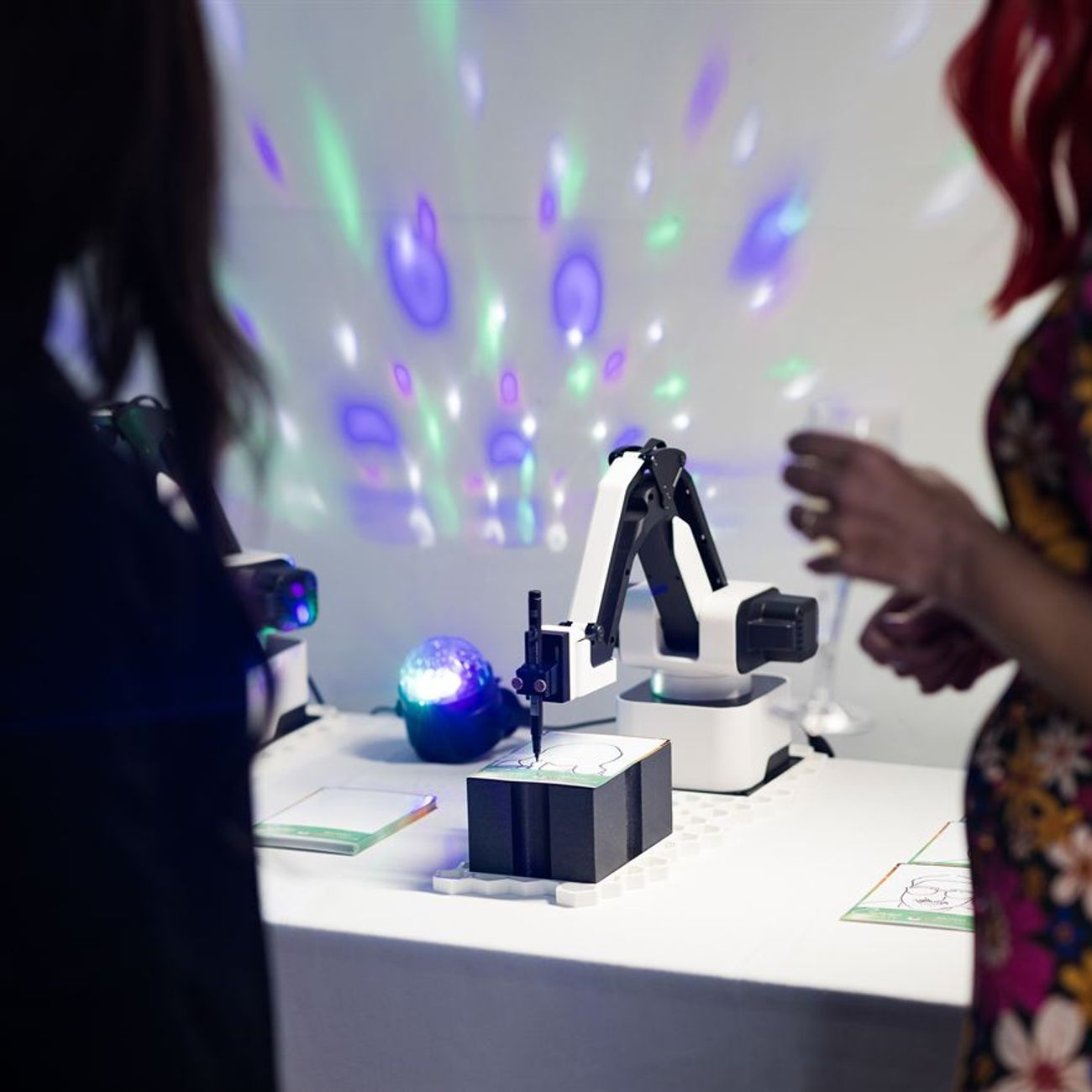 Sketch Robot Guests Watching Arm Draw Disco Lights